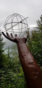 Sculpture: God's hand holding the universe.
